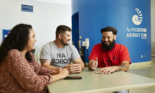 Veteran students chat at a table in the Health, Leisure, and Sports Facility.